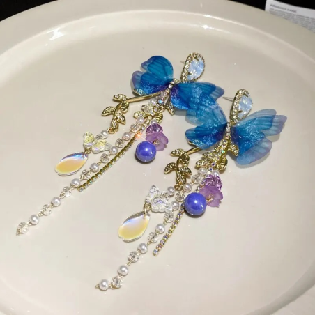 détails des Boucles d'oreilles papillon bleu et pendant de cristaux